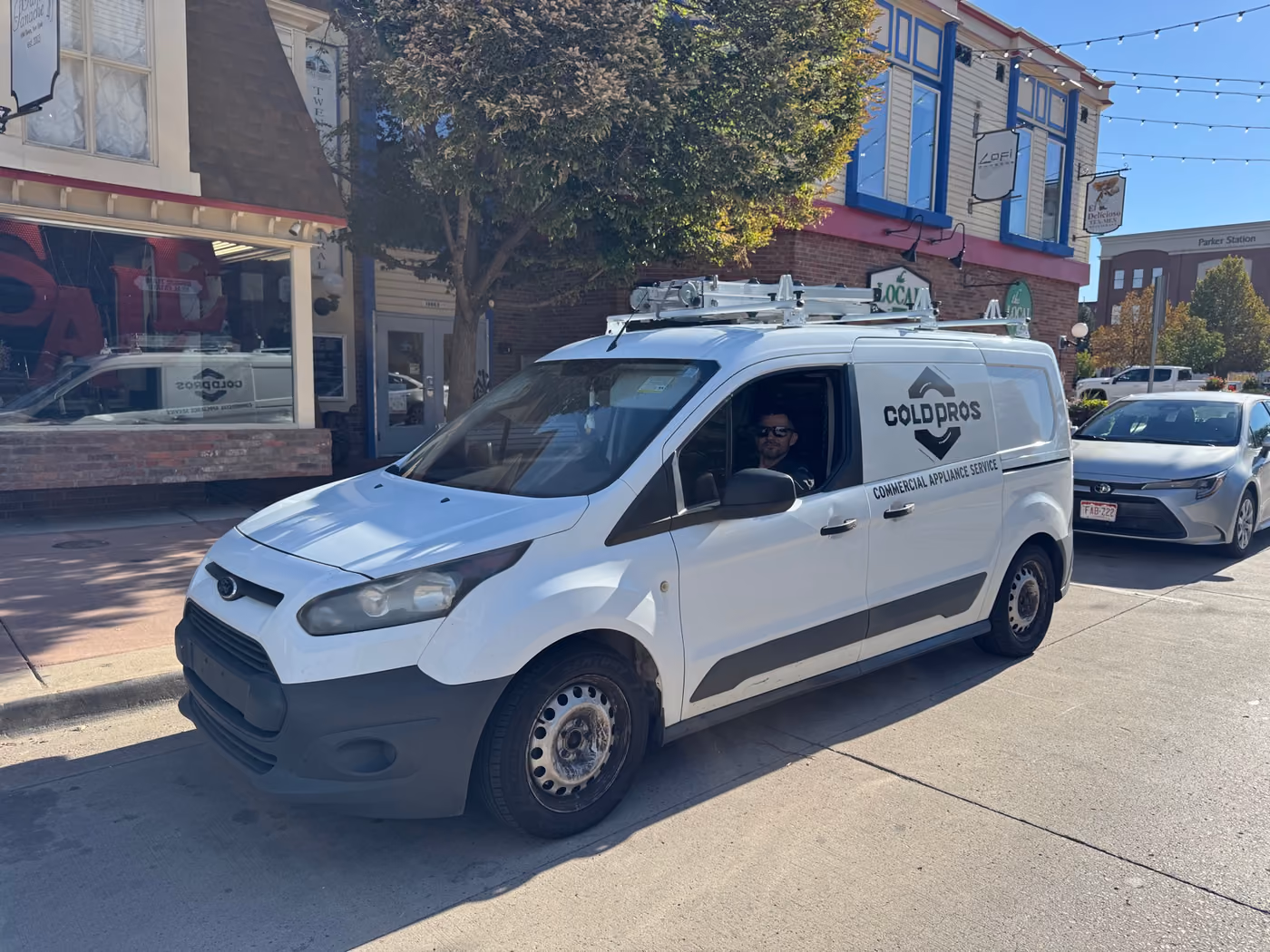 ColdPros service van on Mainstreet in Parker with a technician in the driver’s seat, near Parker Station