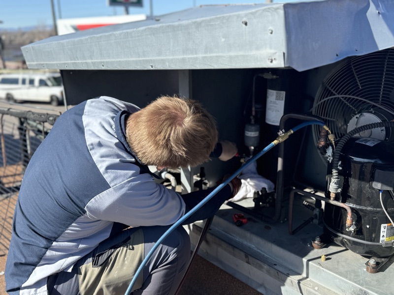 Cold Pros technician repairing a commercial refrigeration condenser unit