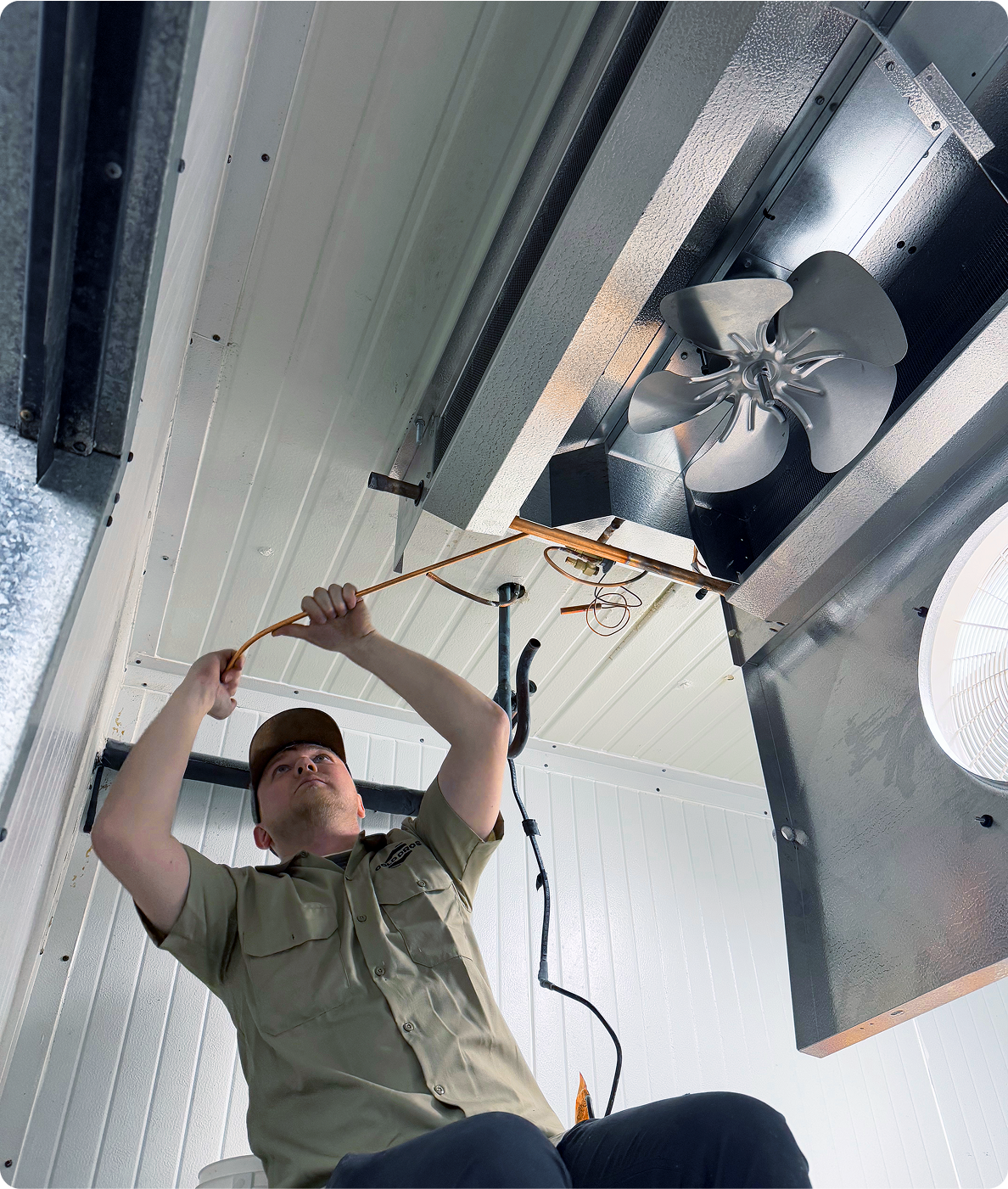 Cold Pros technician installing a walk-in refrigeration evaporator fan